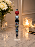 Multicolored pen with red bead