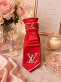 Red tie trimmed in silver with LV brooch