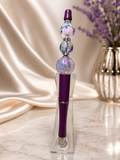 Purple ink pen with clear focal beads