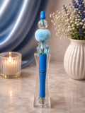 Blue ink pen with furry focal bead
