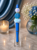 Blue ink pen with glitter focal bead