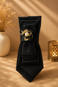Black necktie with black and pearl brooch